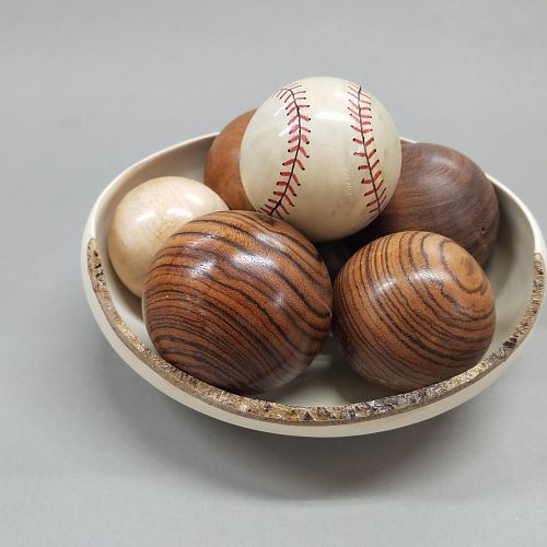 Baseball in a bowl full of balls