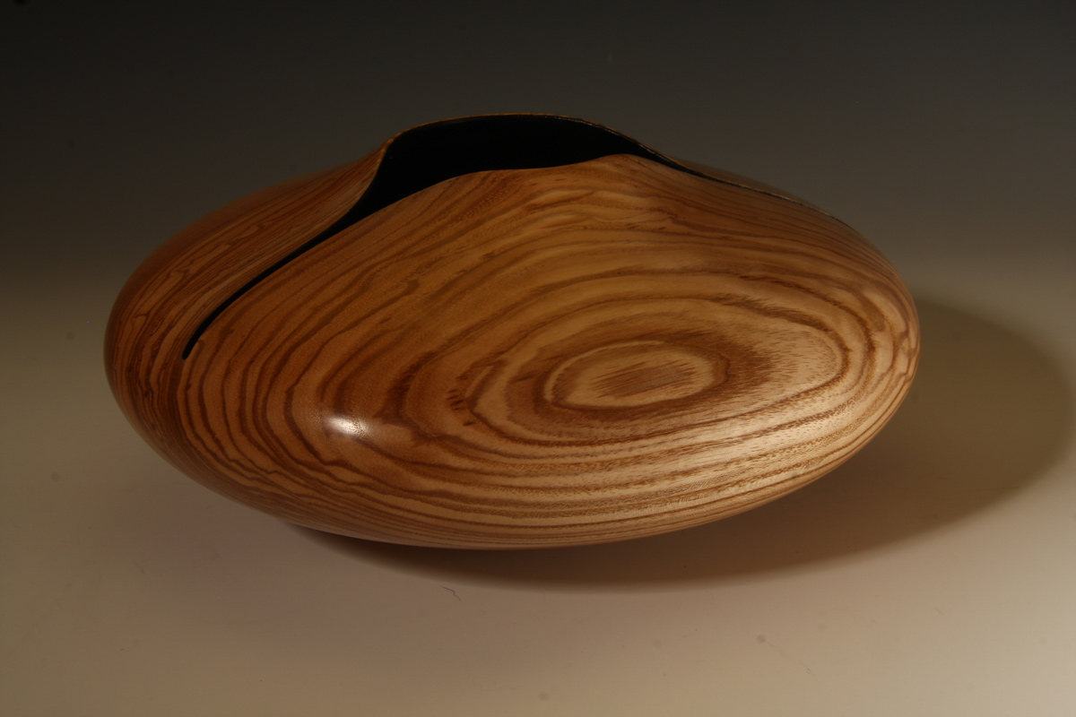 Hollow form with carved rim in Ash