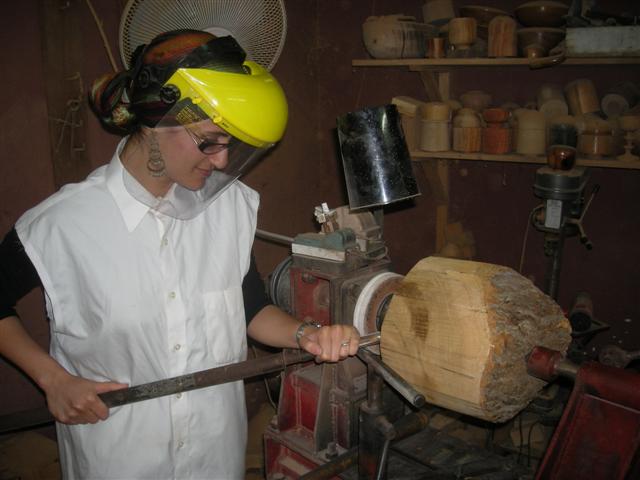 student turning an olive wood bowl