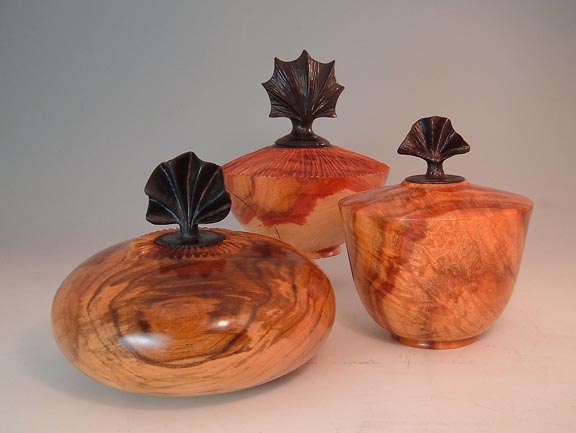 Three Urns with Carved Lids