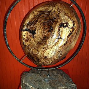 white oak burl set in iron frame mounted on granit