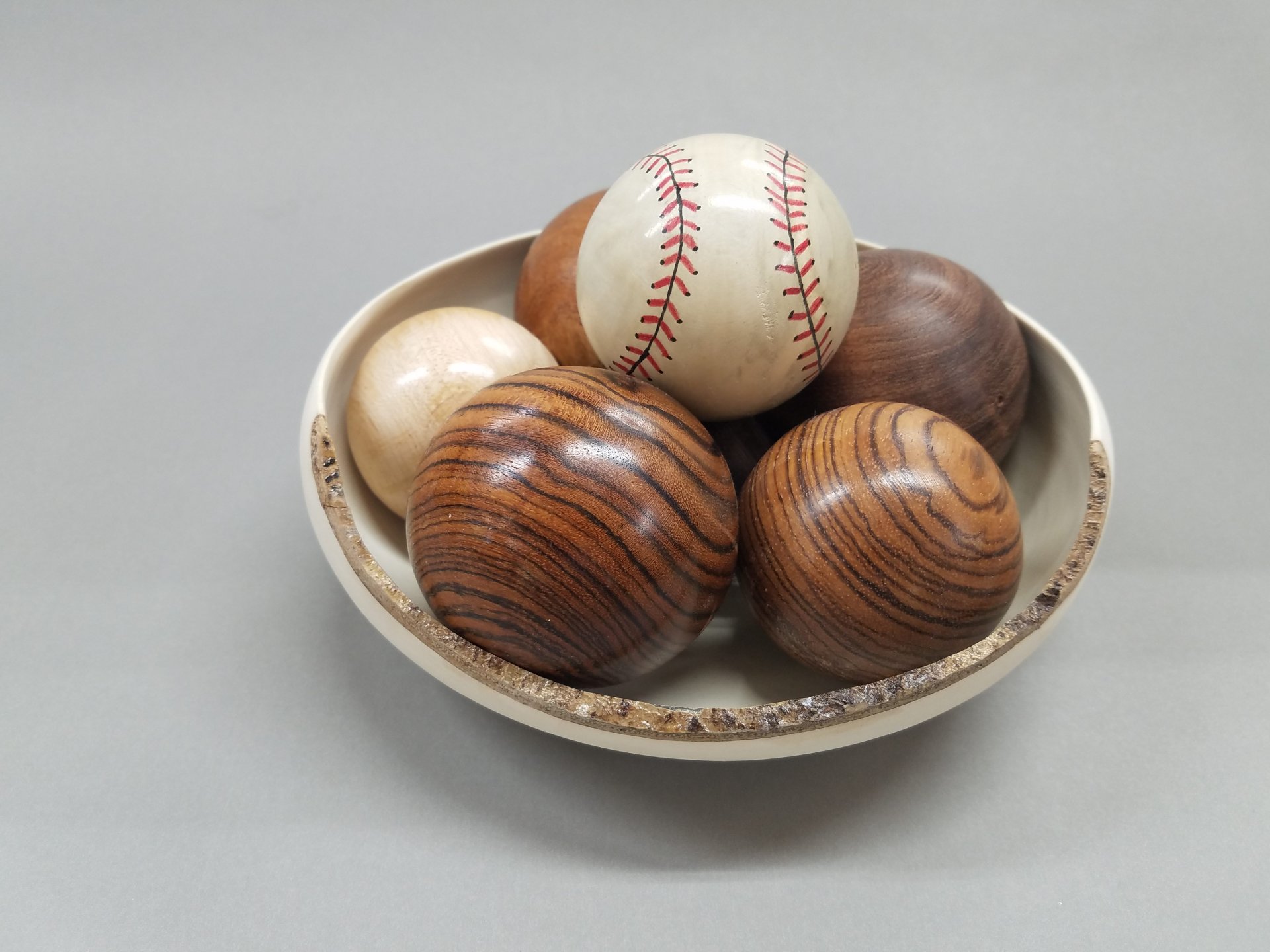 Baseball in a bowl full of balls