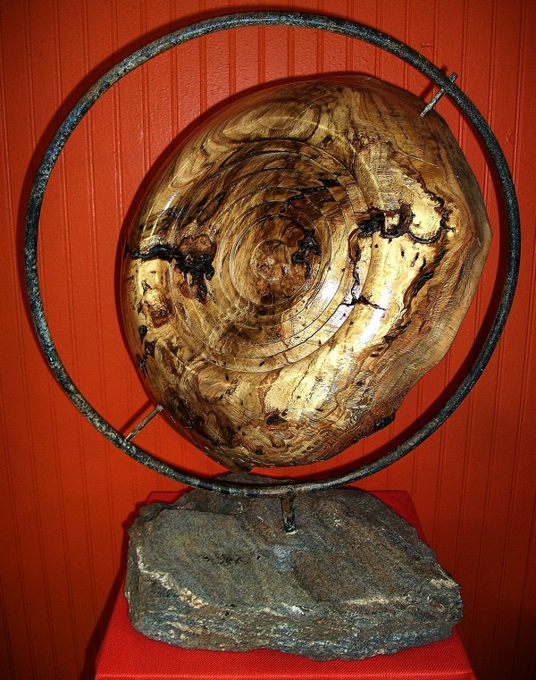 white oak burl set in iron frame mounted on granit
