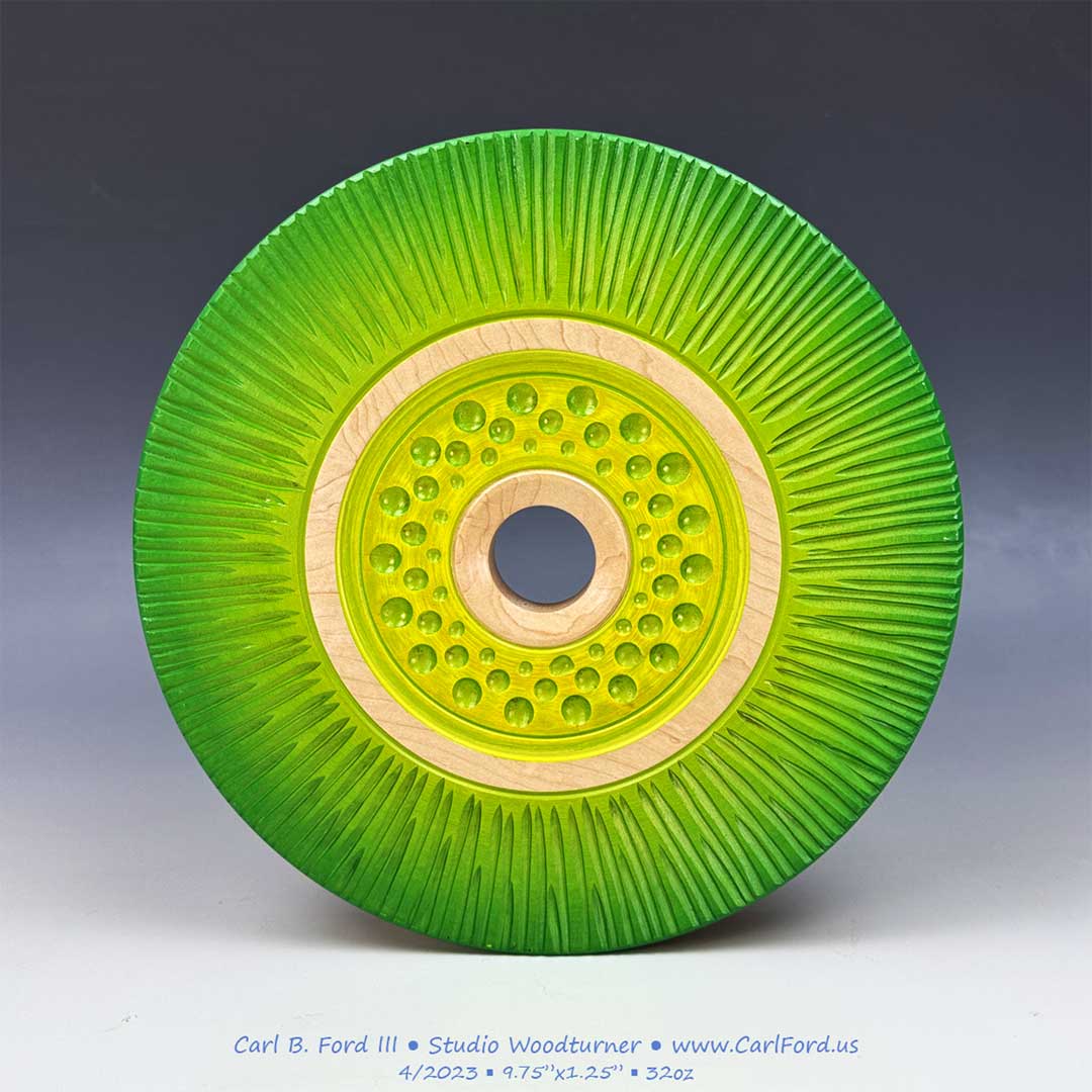 Yellow and Green Carved Wheel Sculpture